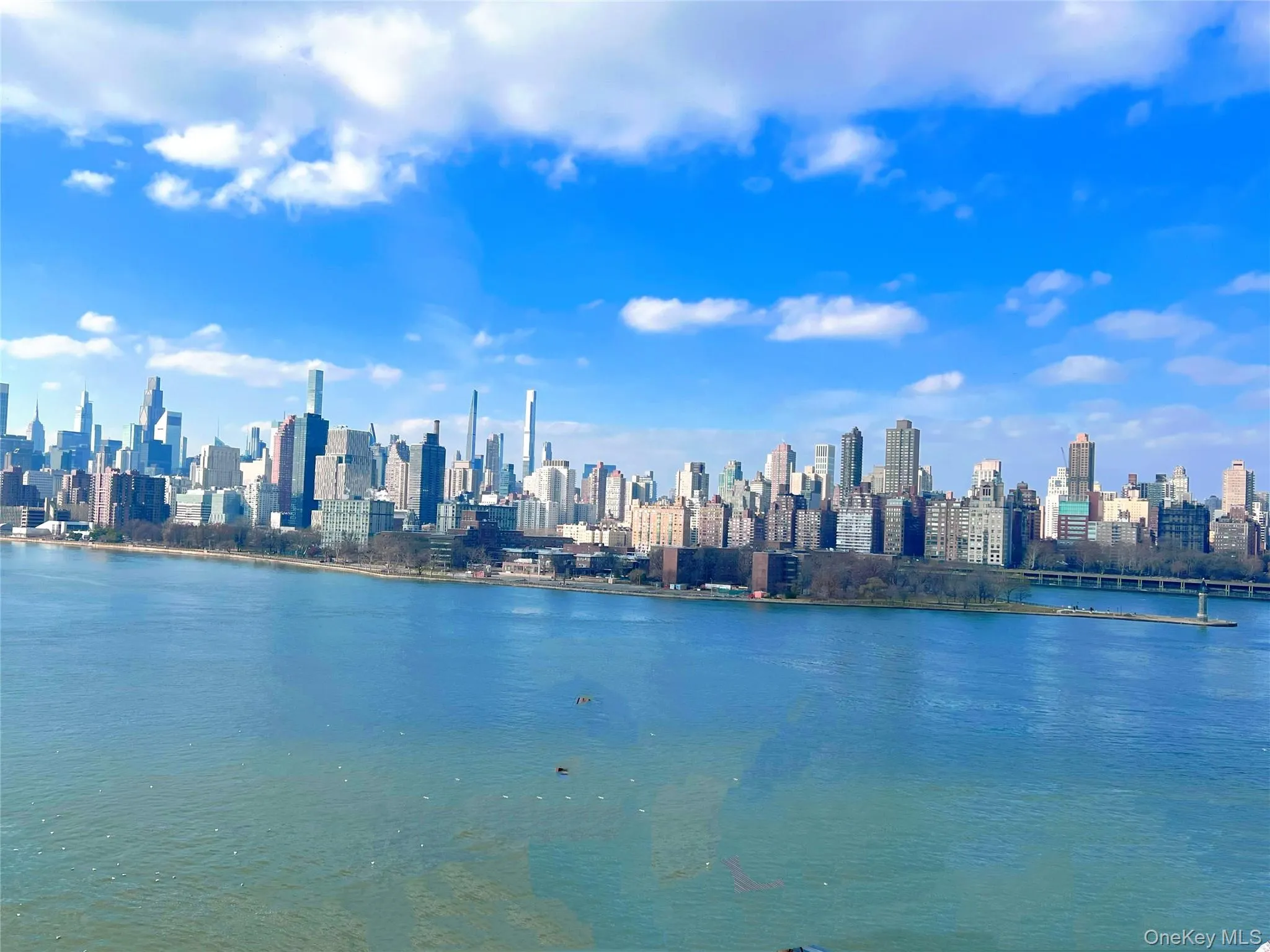 View of city with a nearby body of water View of city with a nearby body of water