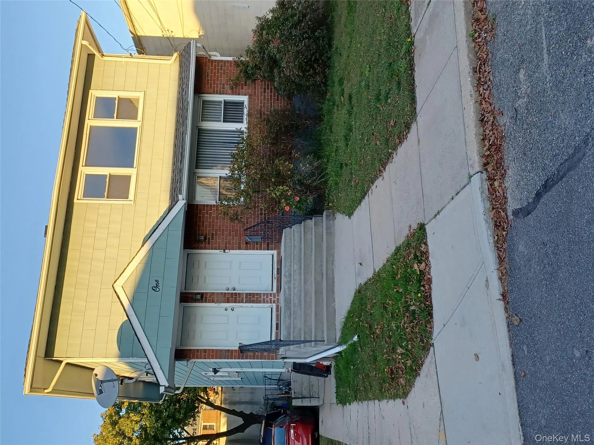 View of front of property featuring brick siding and a front yard View of front of property featuring brick siding and a front yard