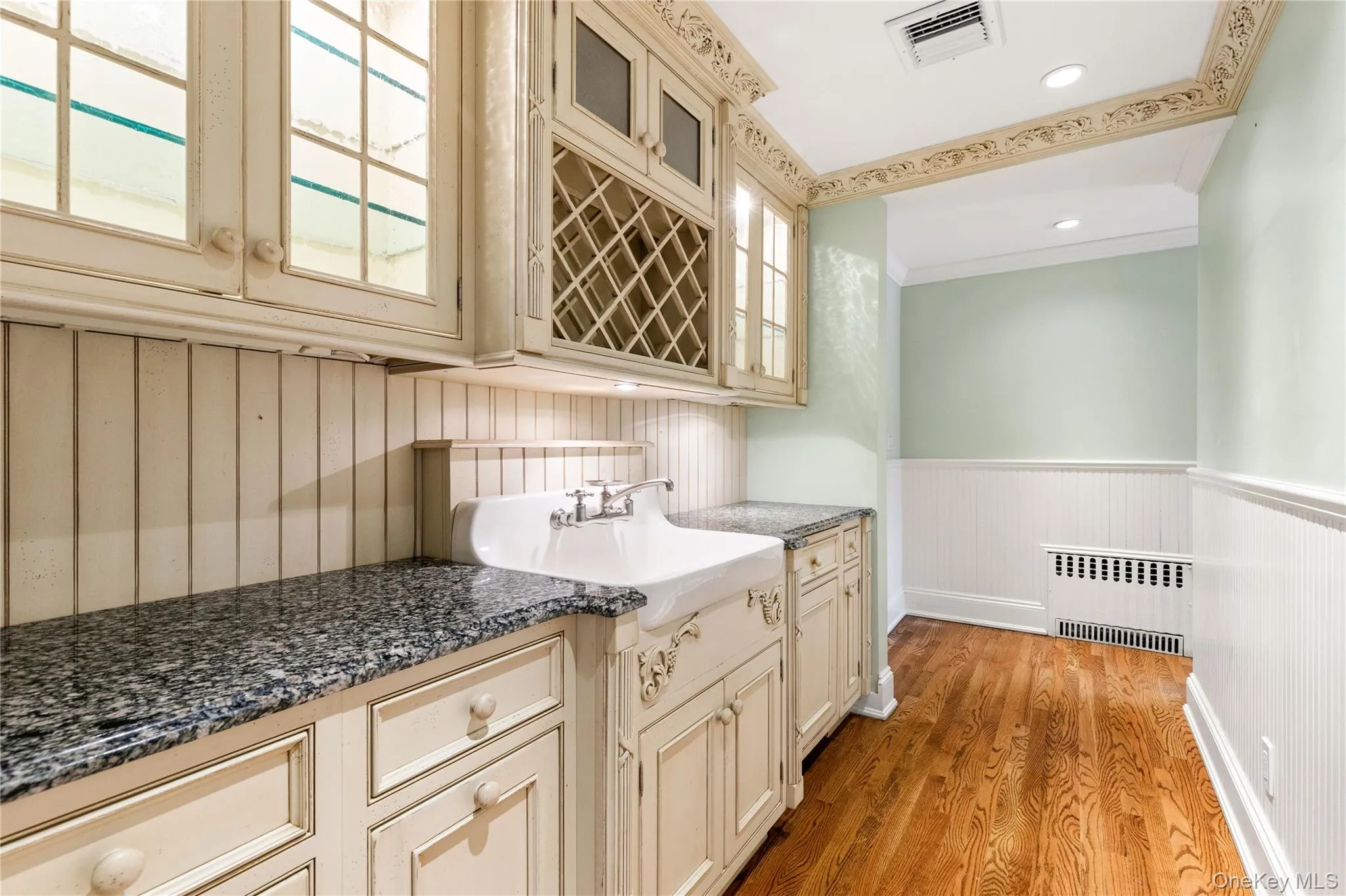 Butler's pantry features beautiful cabinetry with illuminated glass insert cabinets, and essential dishwasher - back stairs up to bedrooms (not pictured) Butler's pantry features beautiful cabinetry with illuminated glass insert cabinets, and essential dishwasher - back stairs up to bedrooms (not pictured)