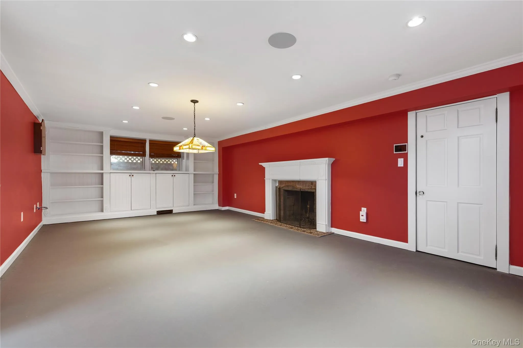 Billiard room/office features custom built-ins, fireplace and door to additional storage room Billiard room/office features custom built-ins, fireplace and door to additional storage room