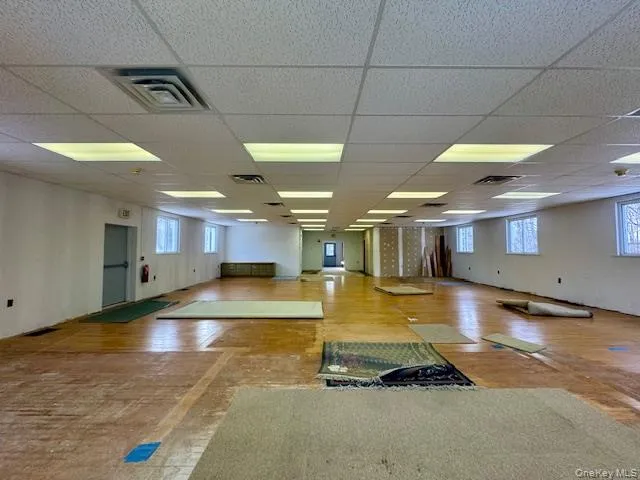 Spare room featuring hardwood / wood-style flooring and a paneled ceiling Spare room featuring hardwood / wood-style flooring and a paneled ceiling