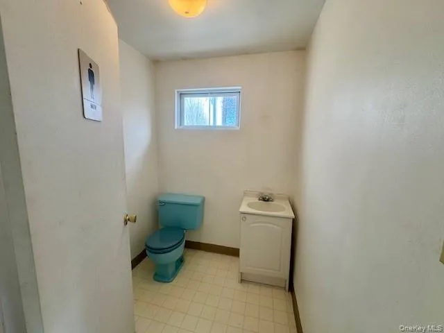 Bathroom featuring toilet and vanity Bathroom featuring toilet and vanity
