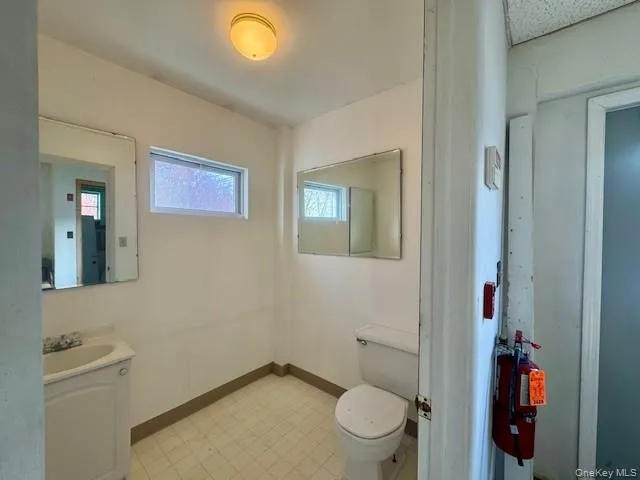 ADA compliant half bathroom featuring vanity and light floors ADA compliant half bathroom featuring vanity and light floors