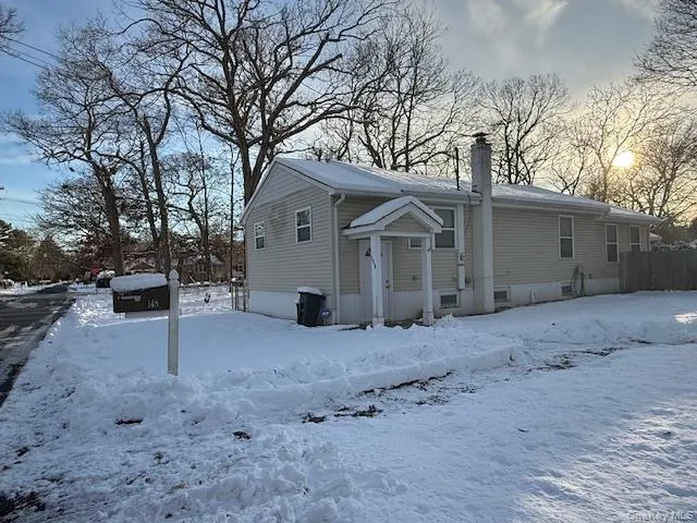 Snow covered house with a chimney Snow covered house with a chimney