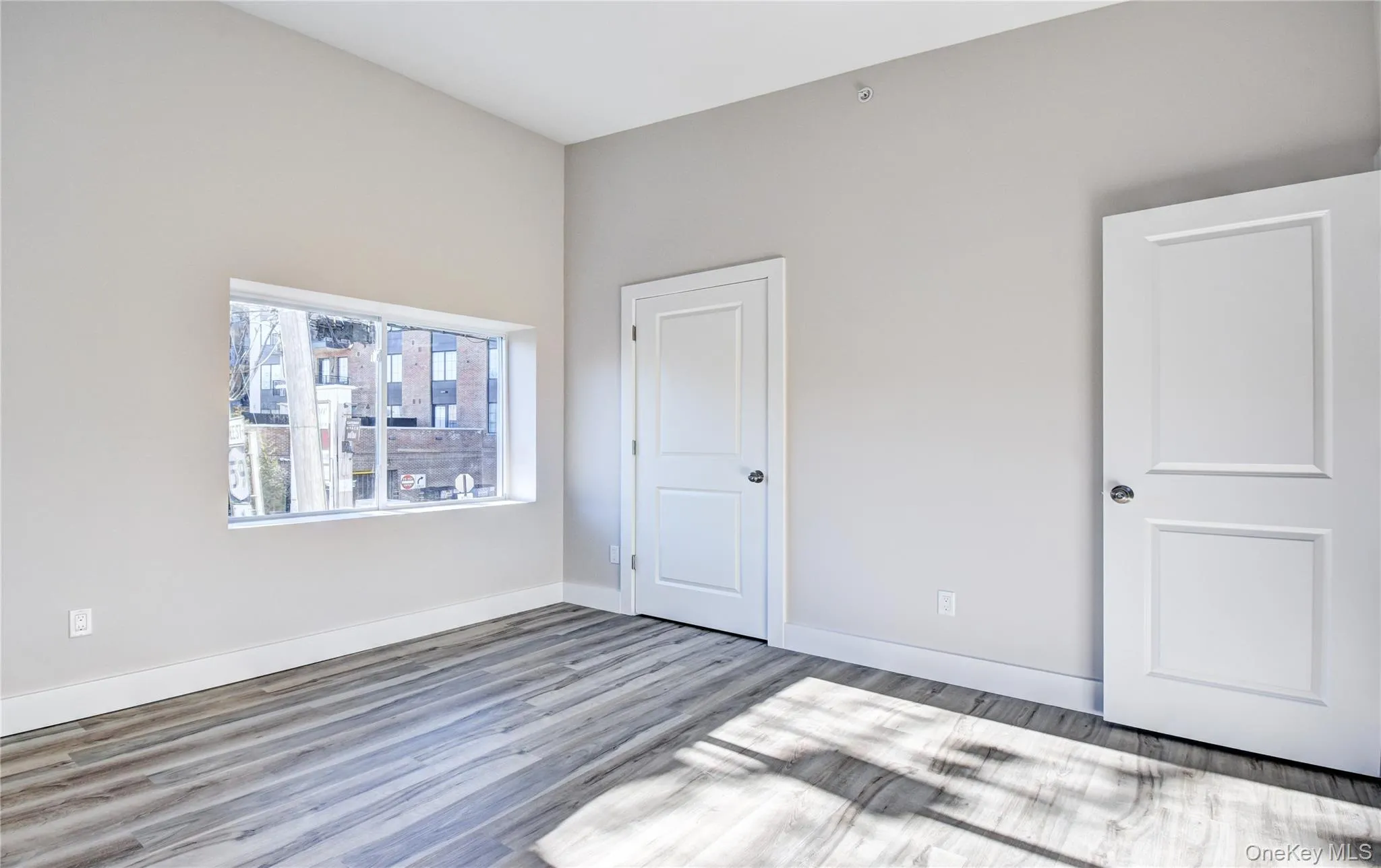 Unfurnished bedroom featuring baseboards and wood finished floors Unfurnished bedroom featuring baseboards and wood finished floors