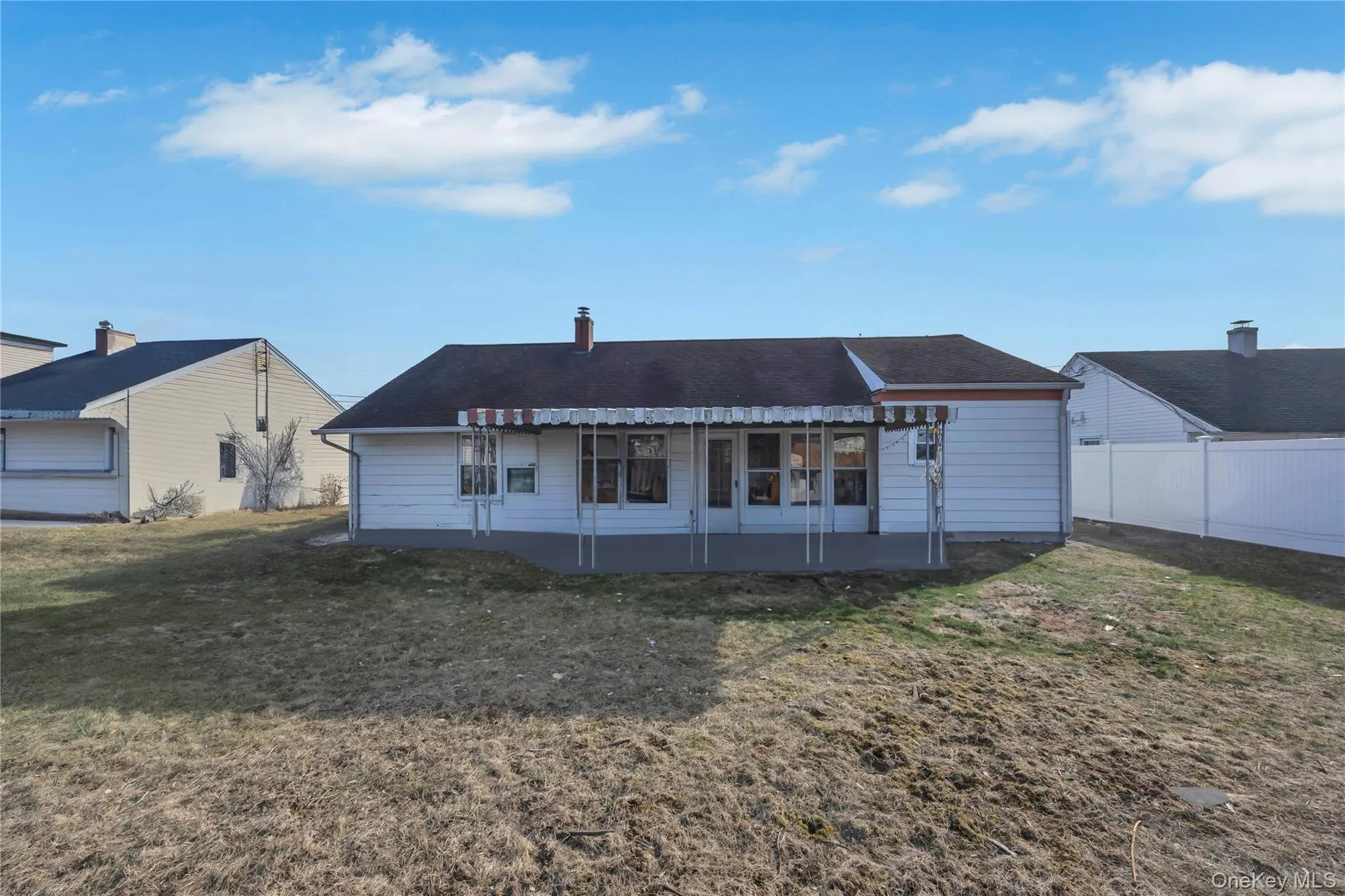 Back of house with a yard and a patio Back of house with a yard and a patio