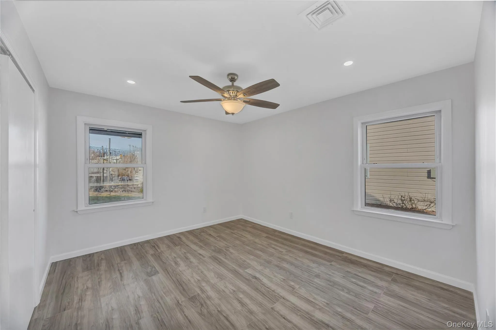 Spare room with light wood-style floors, recessed lighting, and a ceiling fan Spare room with light wood-style floors, recessed lighting, and a ceiling fan
