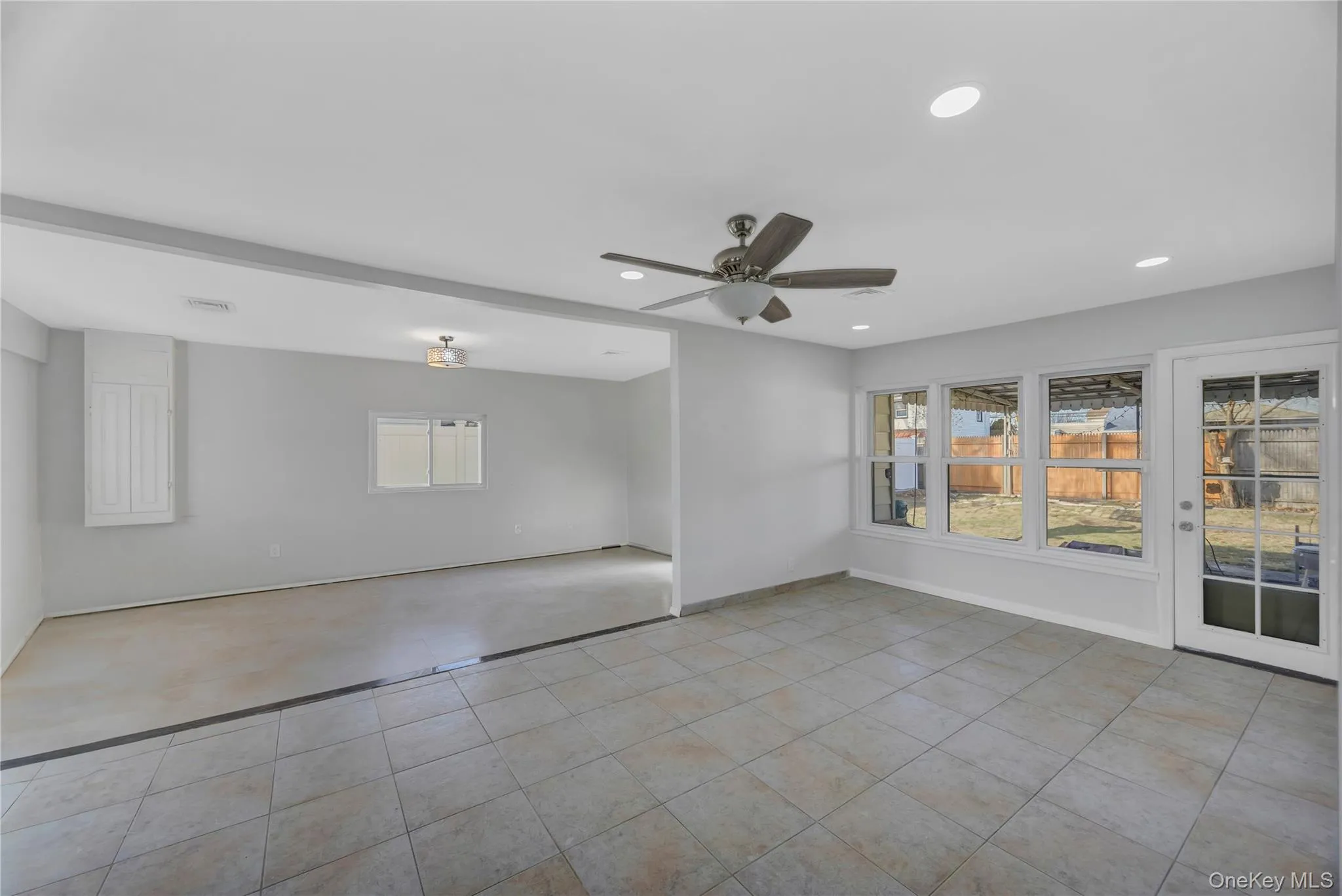 Spare room featuring recessed lighting, light tile patterned floors, and ceiling fan Spare room featuring recessed lighting, light tile patterned floors, and ceiling fan