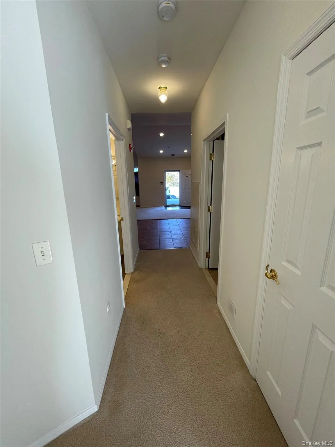 Hall with carpet and baseboards Hall with carpet and baseboards