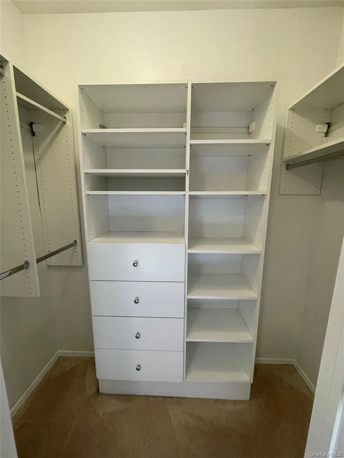 Spacious closet featuring carpet flooring Spacious closet featuring carpet flooring