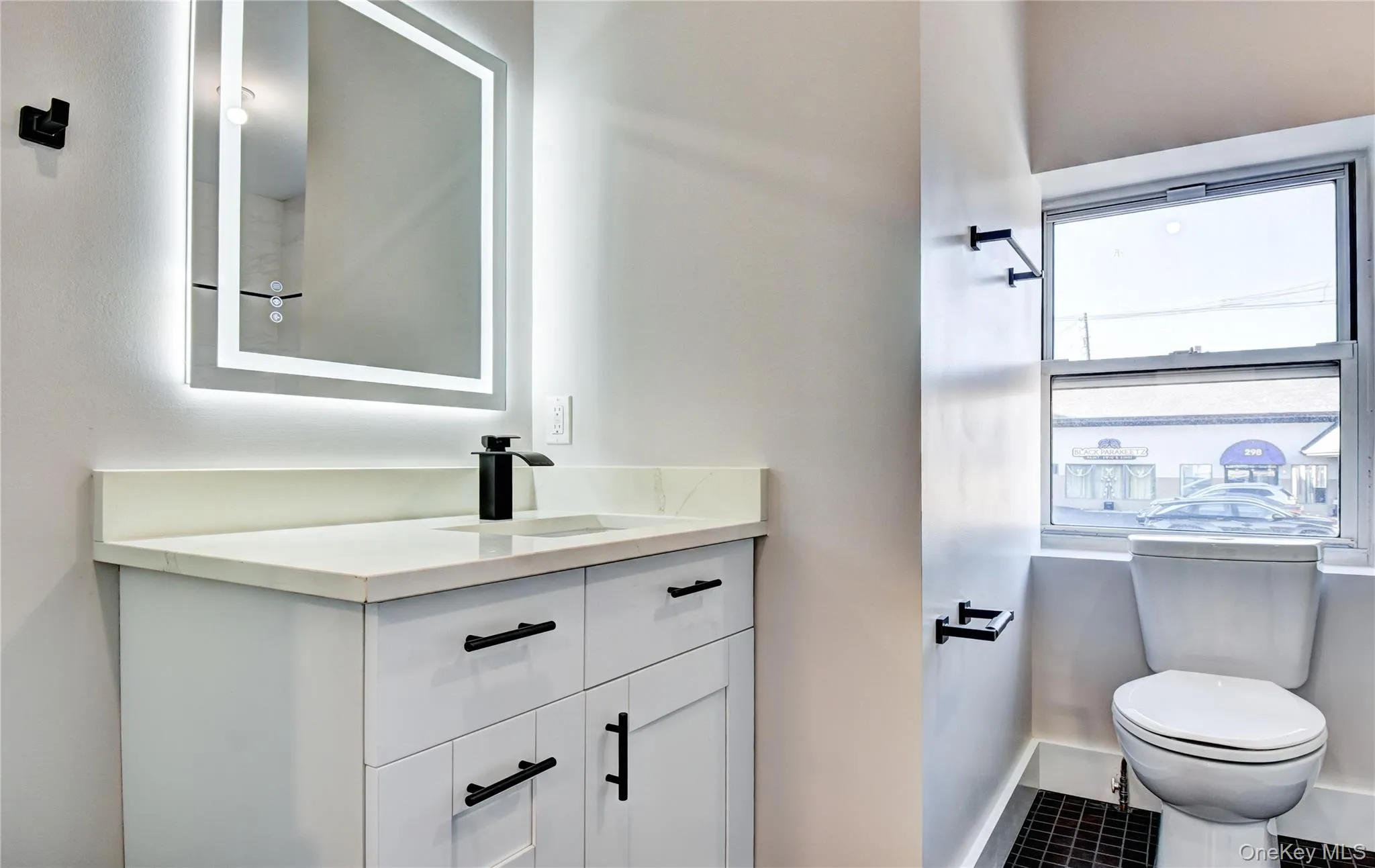 Bathroom featuring vanity and toilet Bathroom featuring vanity and toilet