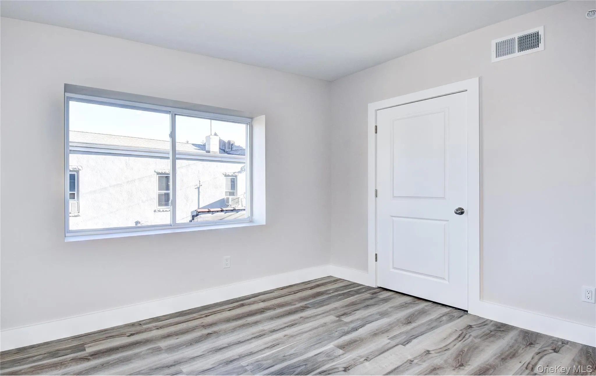 Empty room featuring light wood finished floors and baseboards Empty room featuring light wood finished floors and baseboards