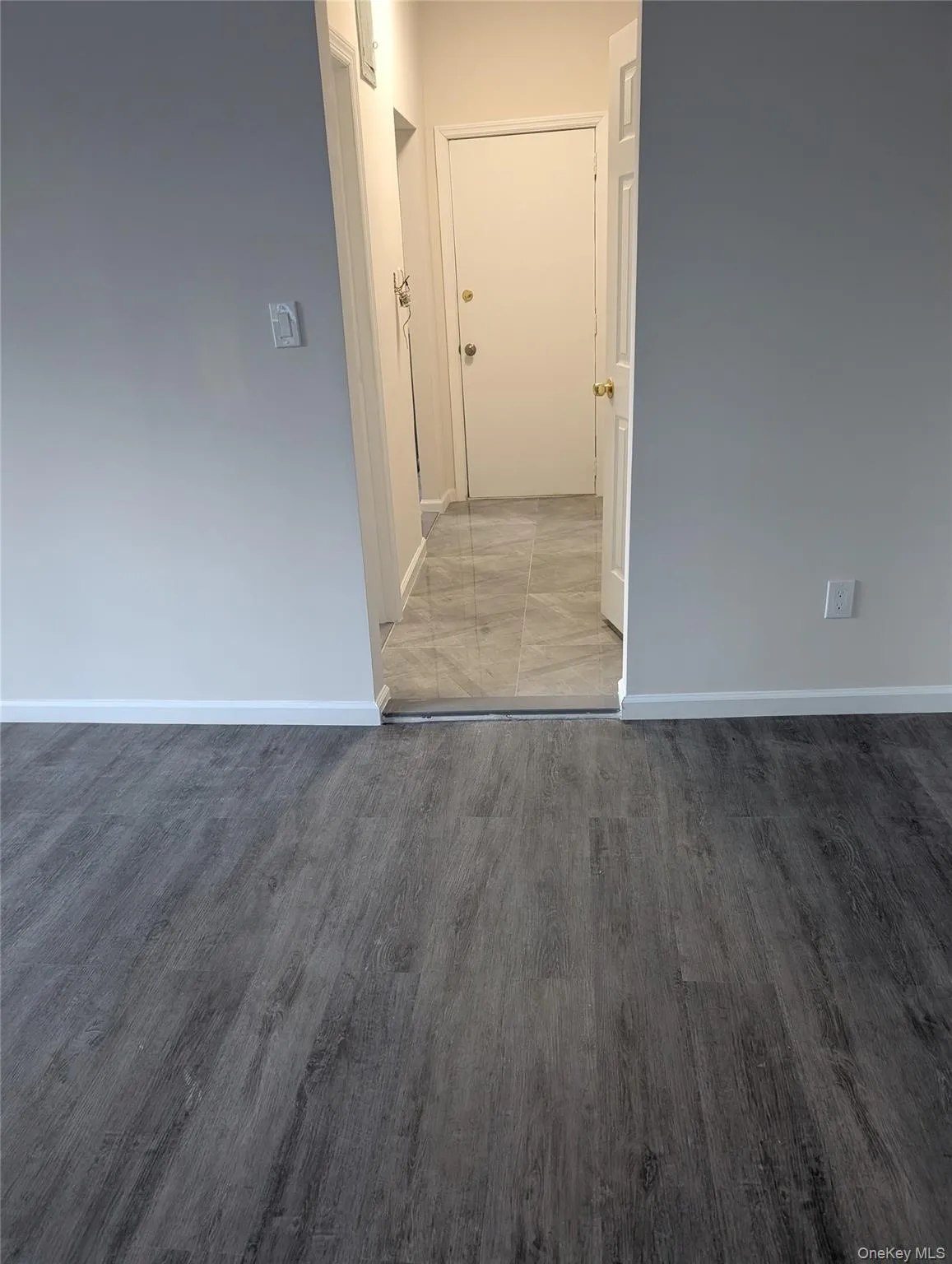 Spare room with baseboards and light wood finished floors Spare room with baseboards and light wood finished floors