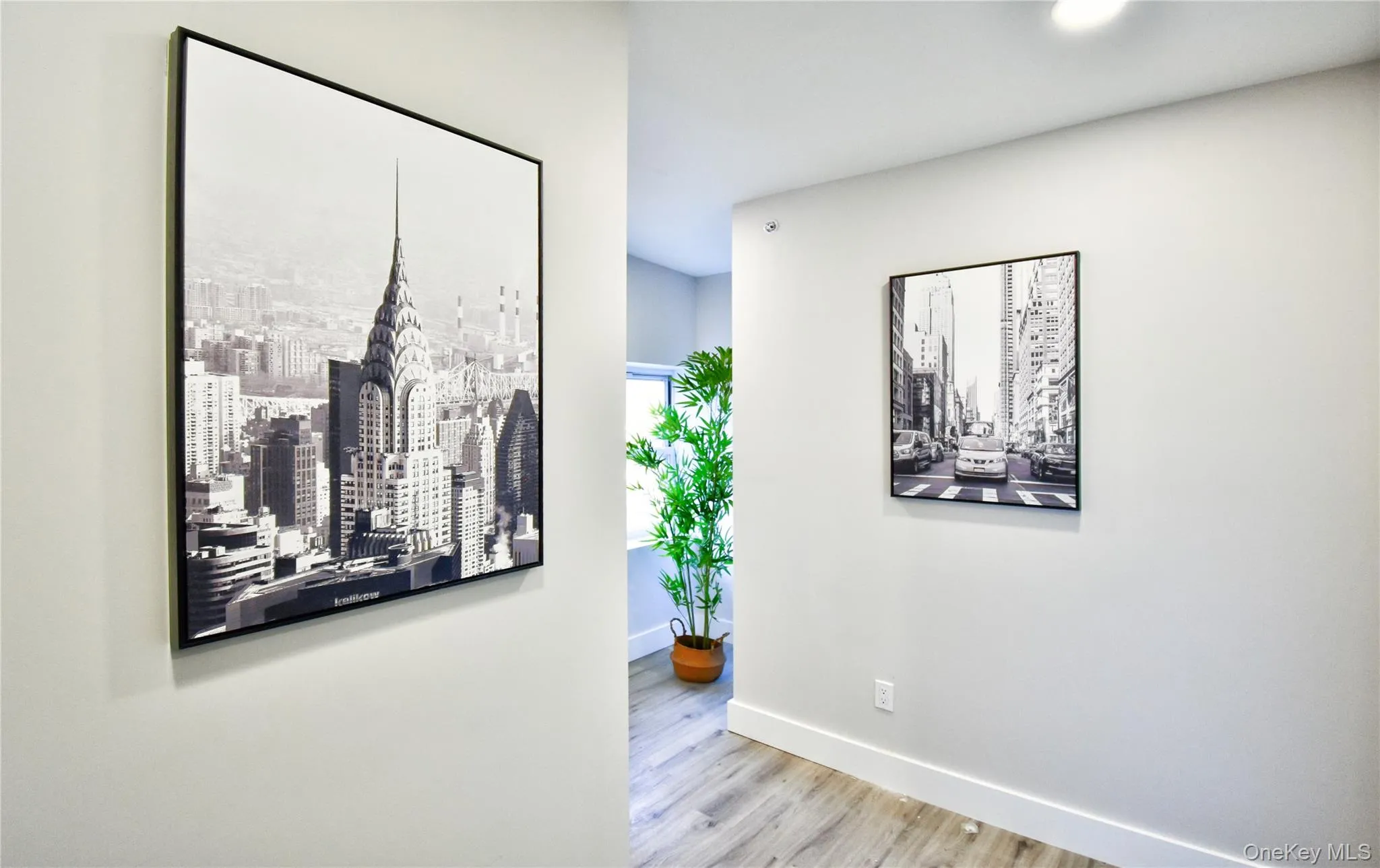 Corridor with baseboards and wood finished floors Corridor with baseboards and wood finished floors