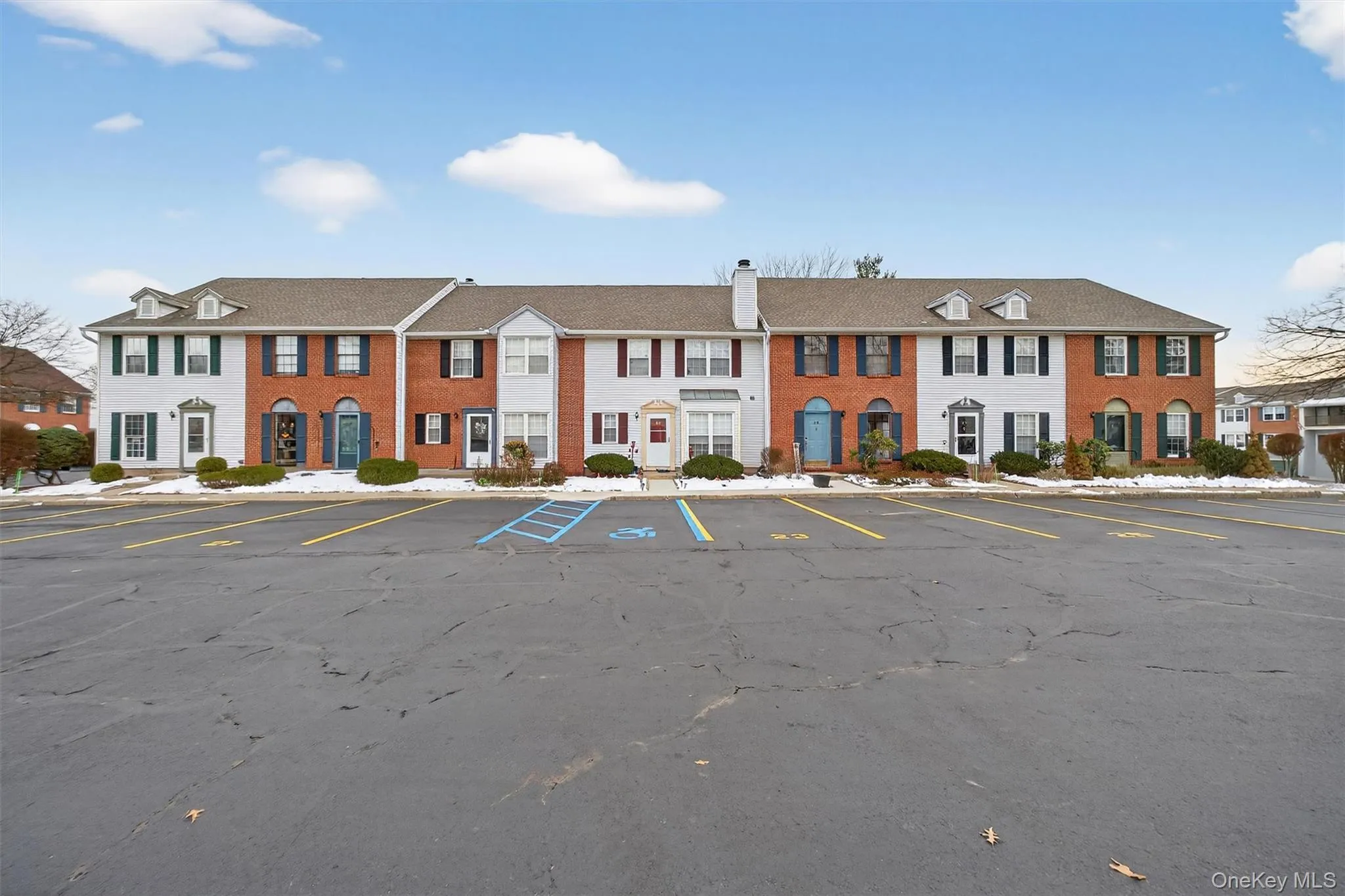 View of property featuring uncovered parking and a residential view View of property featuring uncovered parking and a residential view
