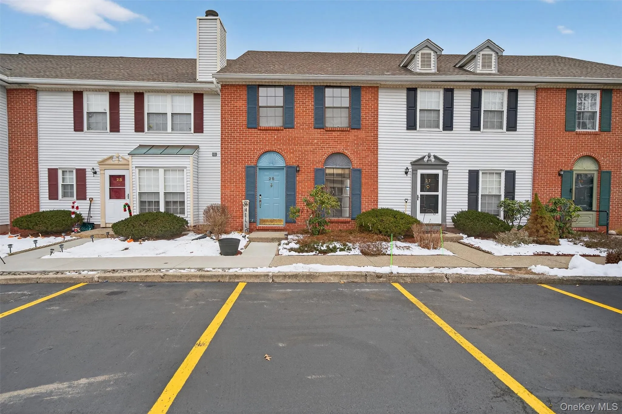 Colonial-style house with uncovered parking and a chimney Colonial-style house with uncovered parking and a chimney