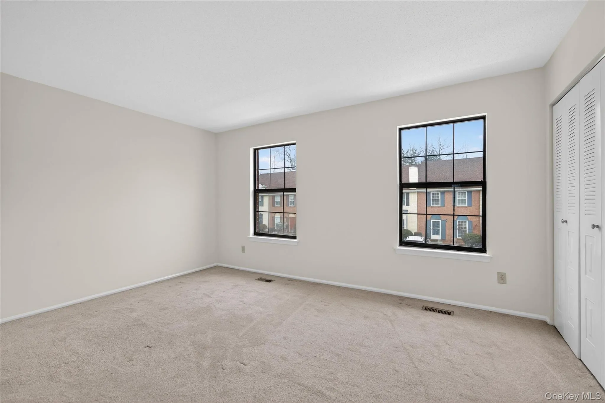 Unfurnished bedroom with a closet and carpet floors Unfurnished bedroom with a closet and carpet floors