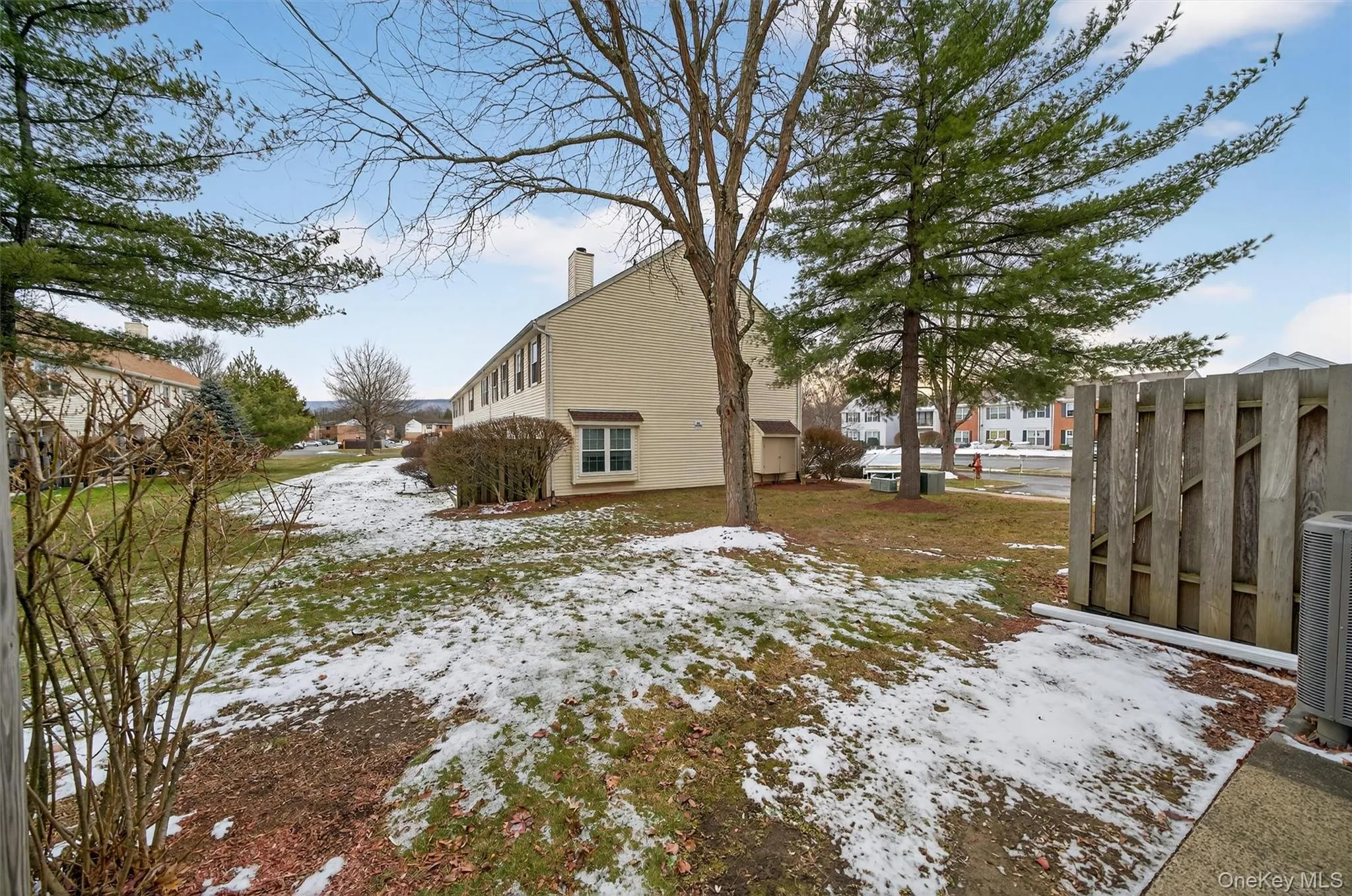 View of snow covered exterior with a chimney and a central AC unit View of snow covered exterior with a chimney and a central AC unit