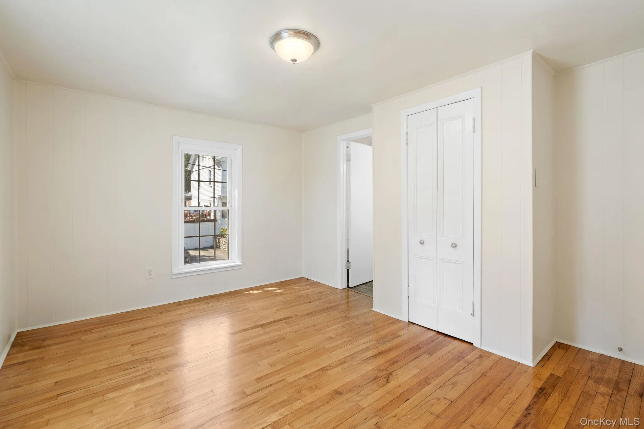 Unfurnished bedroom featuring light wood-style floors and a closet Unfurnished bedroom featuring light wood-style floors and a closet