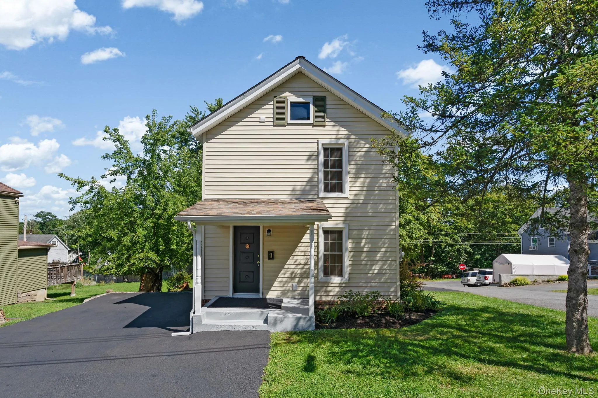Traditional-style house featuring a front yard Traditional-style house featuring a front yard