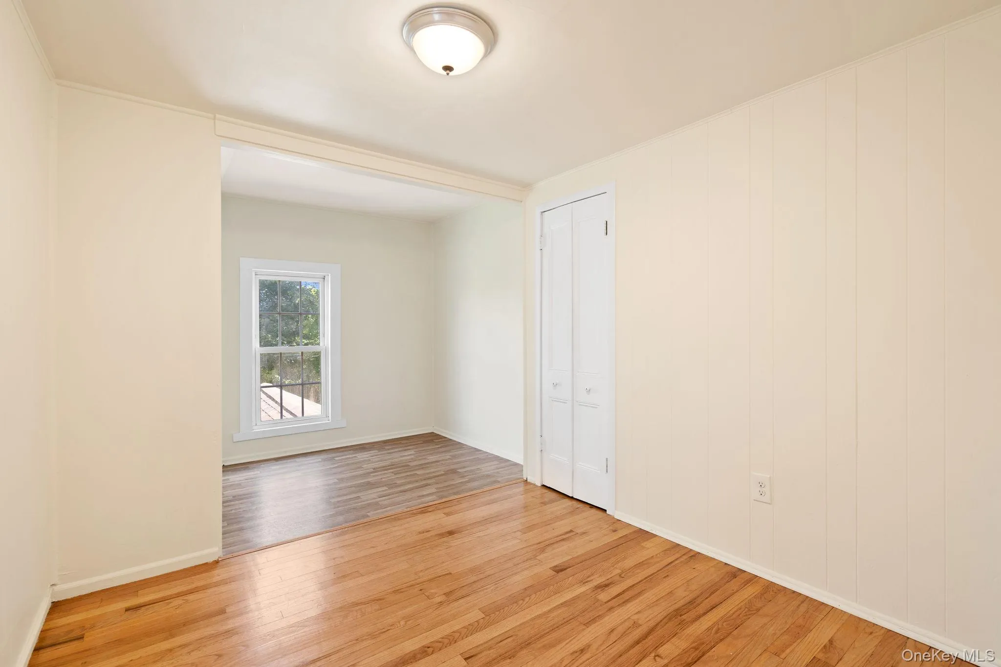 Spare room featuring light wood-style flooring and baseboards Spare room featuring light wood-style flooring and baseboards
