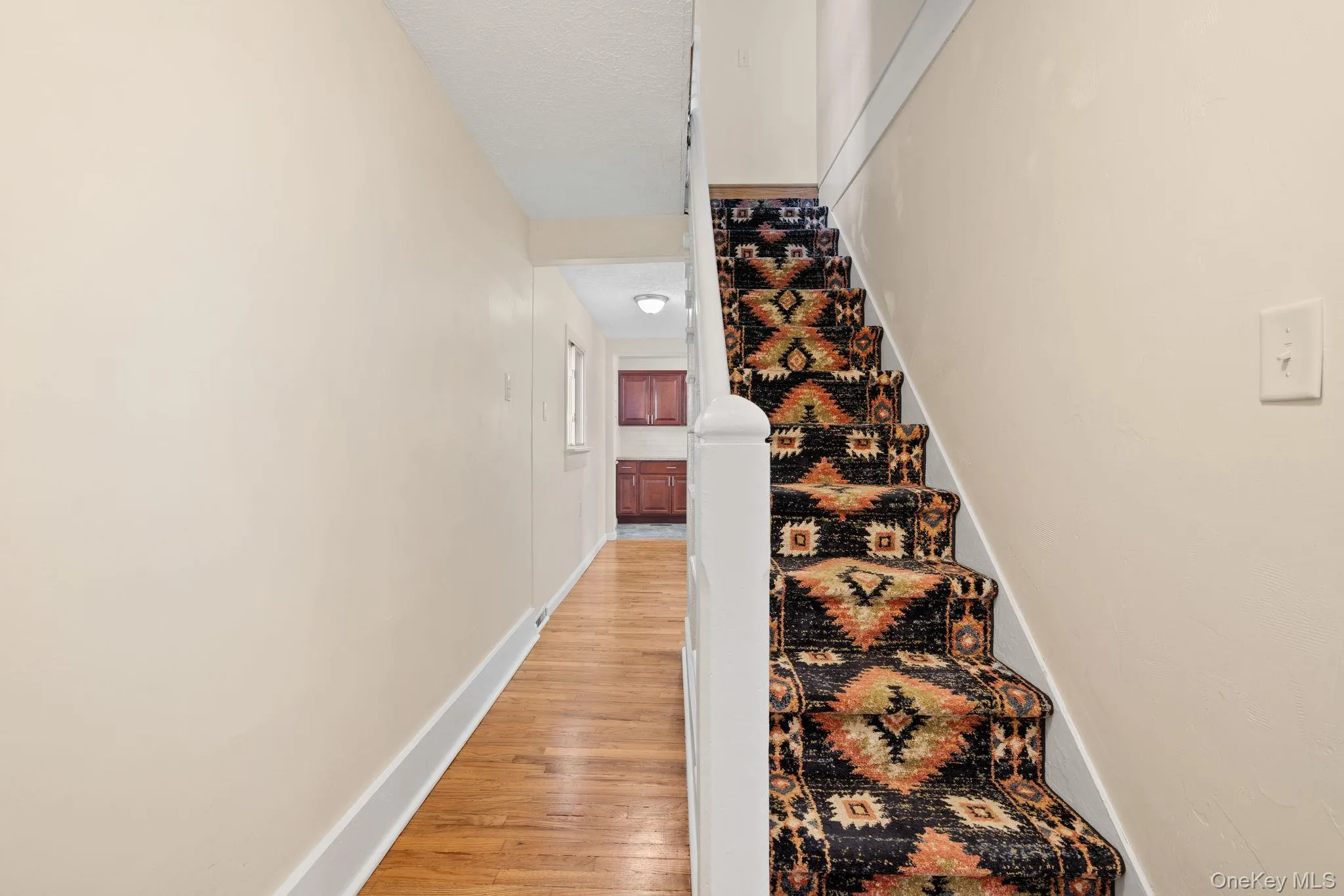 Staircase with wood finished floors and baseboards Staircase with wood finished floors and baseboards