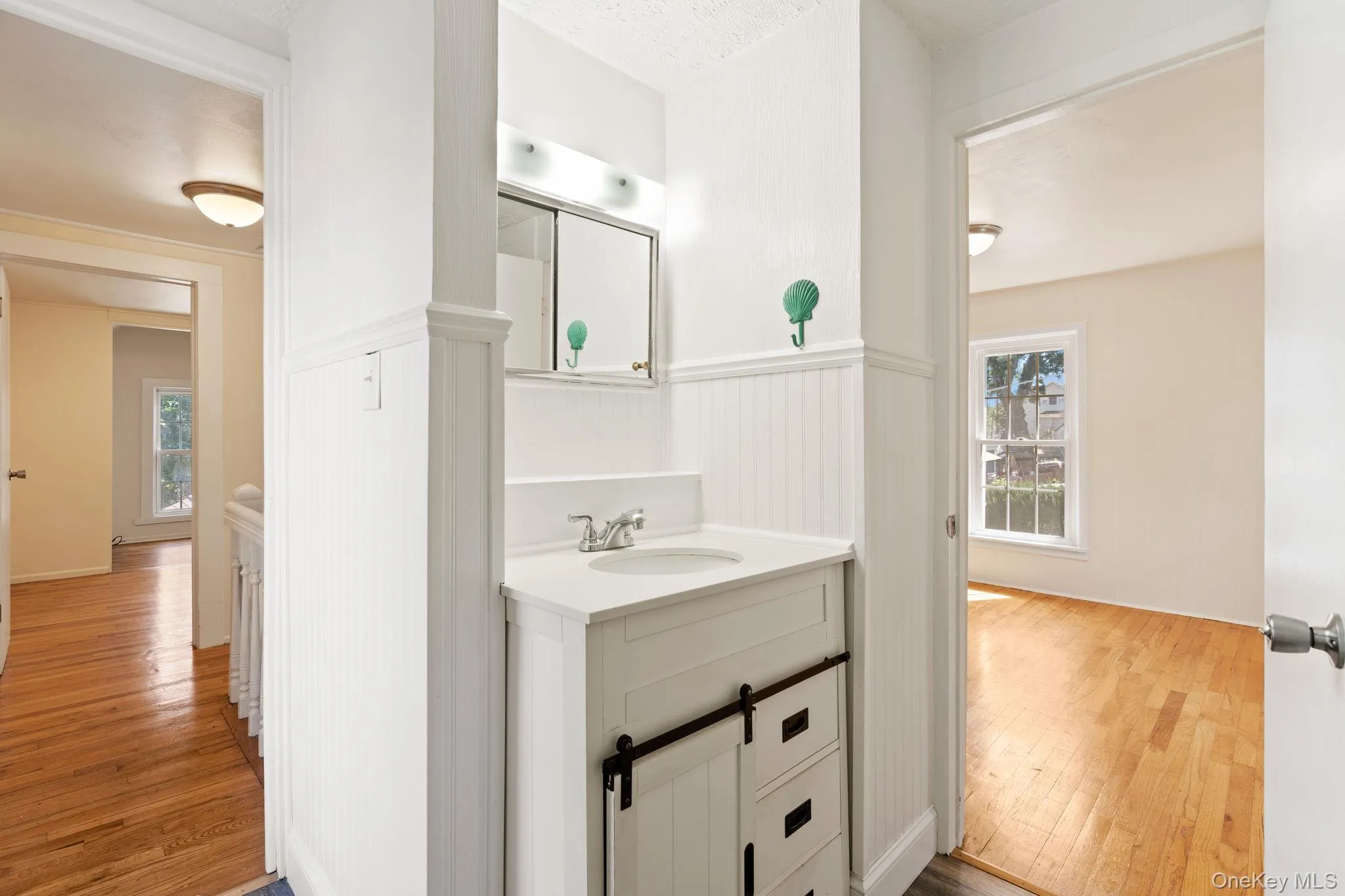 Bathroom featuring vanity and light wood-type flooring Bathroom featuring vanity and light wood-type flooring