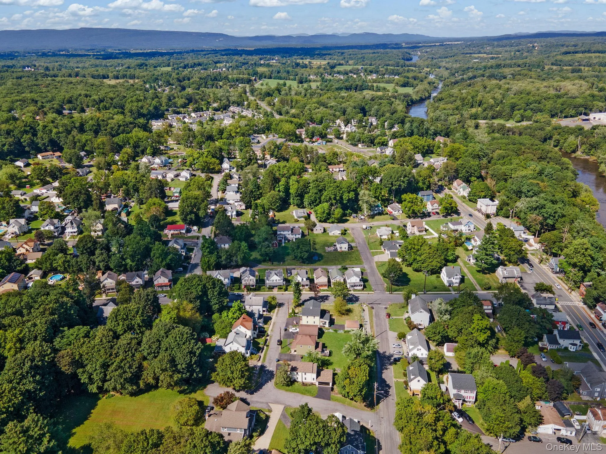 Aerial overview of property's location featuring nearby suburban area and a large body of water Aerial overview of property's location featuring nearby suburban area and a large body of water