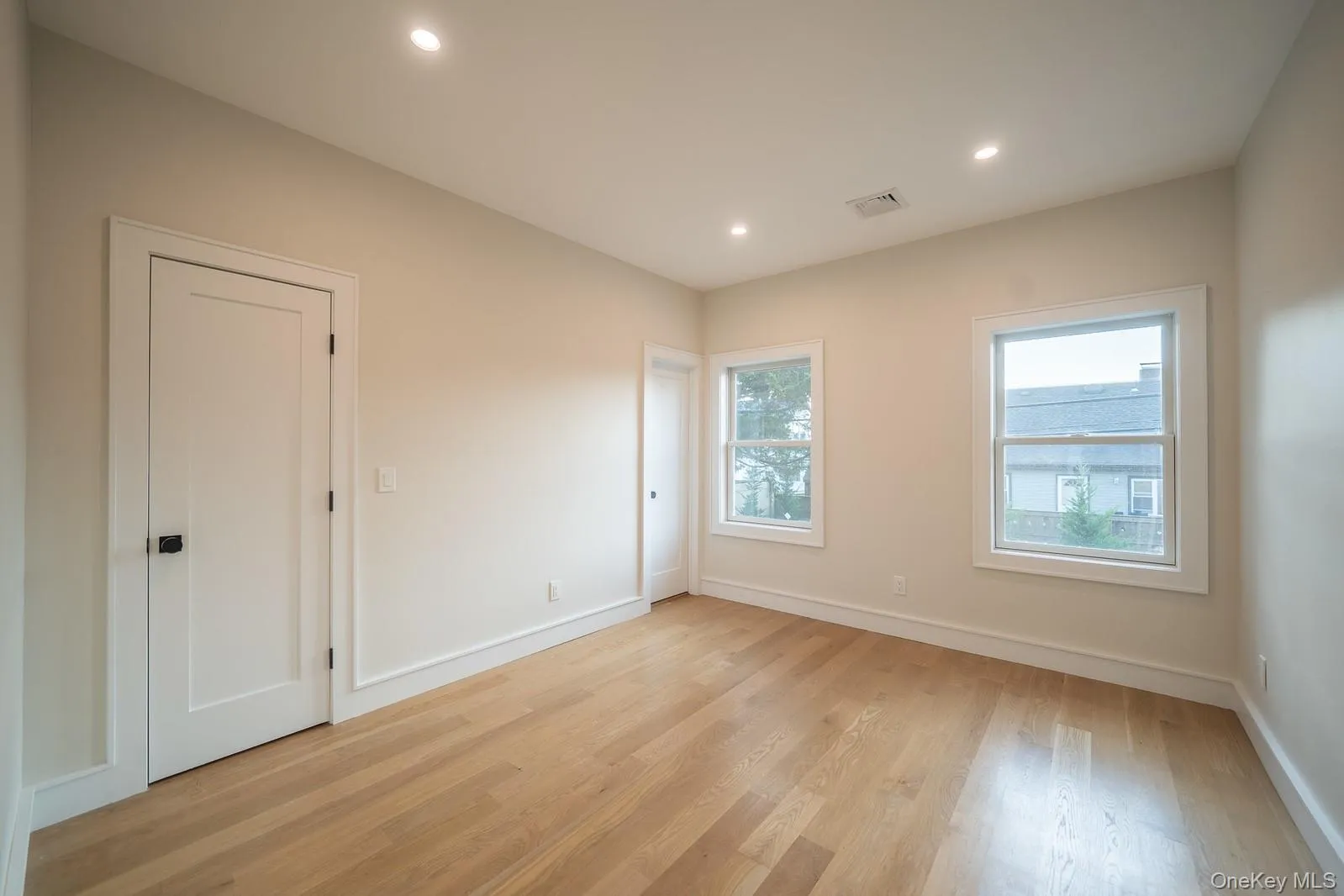 Unfurnished room featuring light wood finished floors and recessed lighting Unfurnished room featuring light wood finished floors and recessed lighting