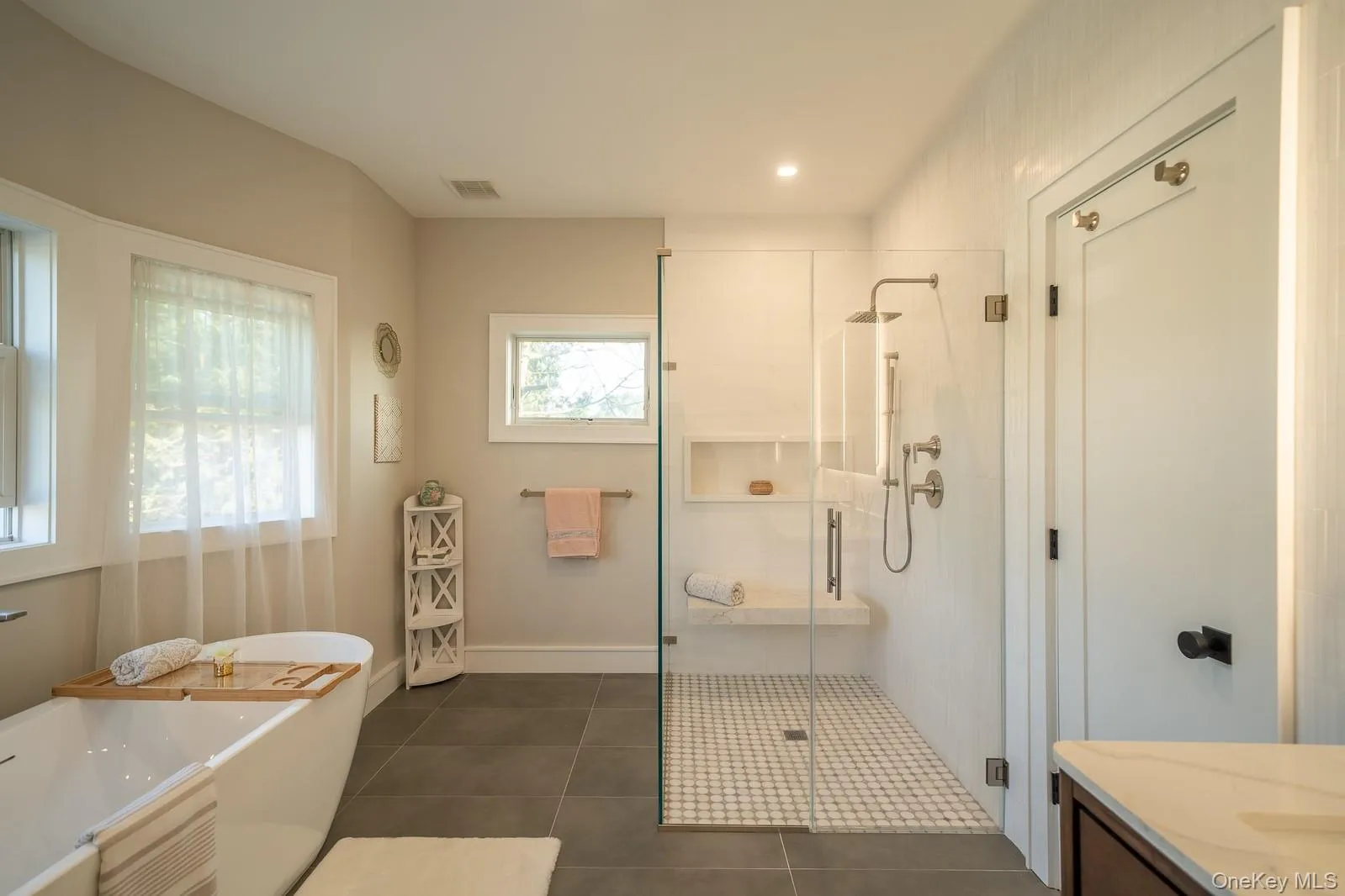 Full bathroom featuring a soaking tub, a shower stall, vanity, tile patterned flooring, and recessed lighting Full bathroom featuring a soaking tub, a shower stall, vanity, tile patterned flooring, and recessed lighting