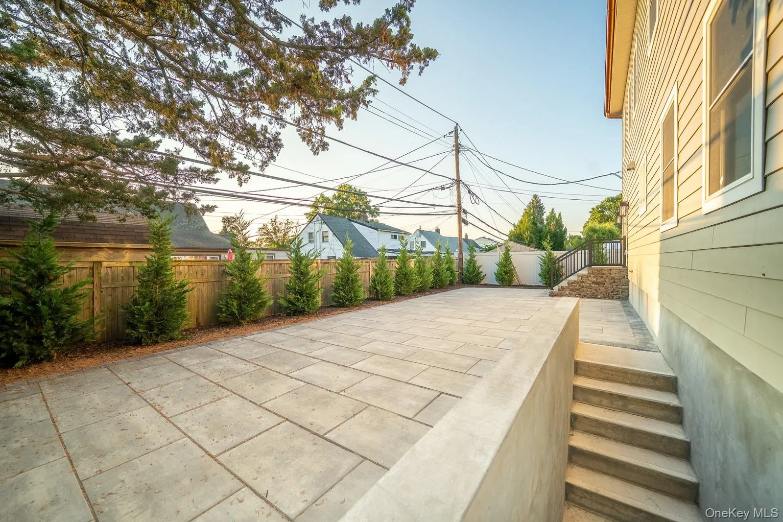 Fenced backyard featuring a patio area and stairs Fenced backyard featuring a patio area and stairs