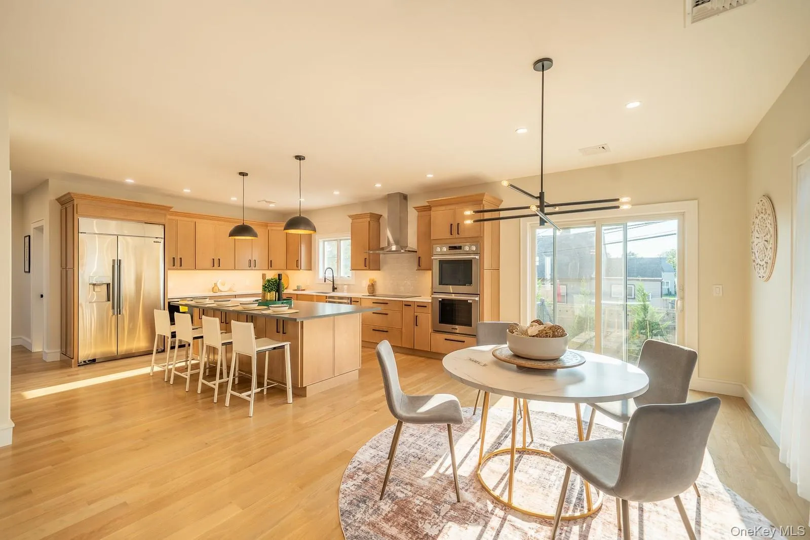 Dining space with light wood-type flooring, recessed lighting, and a chandelier Dining space with light wood-type flooring, recessed lighting, and a chandelier
