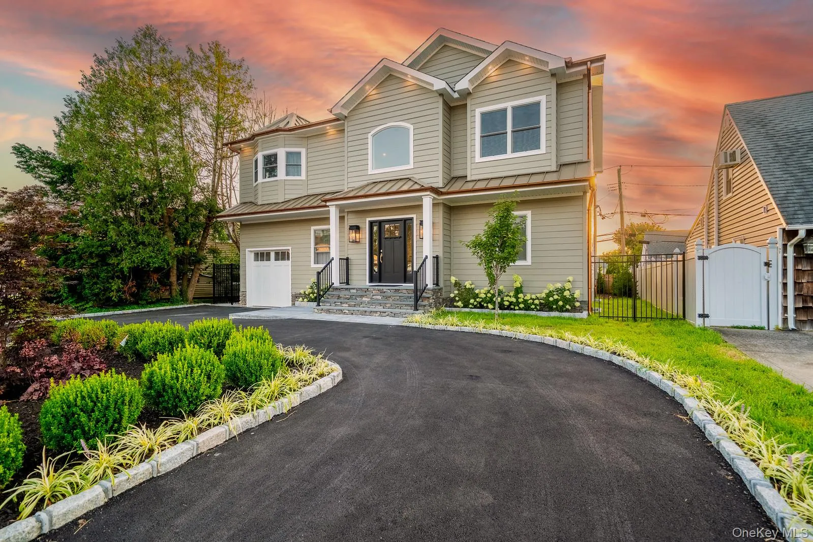 View of front of house featuring driveway, a gate, a garage, and a metal roof View of front of house featuring driveway, a gate, a garage, and a metal roof