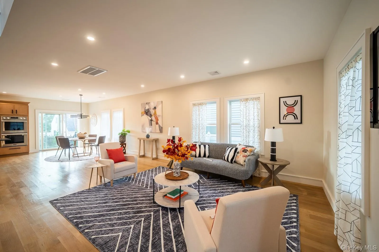 Living room featuring light wood finished floors and recessed lighting Living room featuring light wood finished floors and recessed lighting