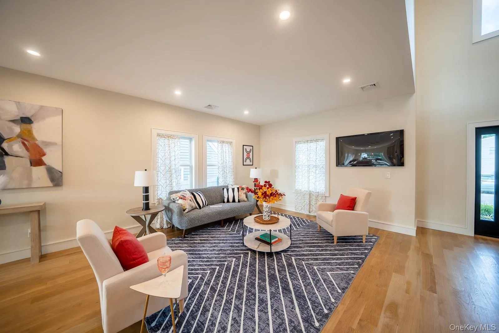Living area featuring wood finished floors and recessed lighting Living area featuring wood finished floors and recessed lighting