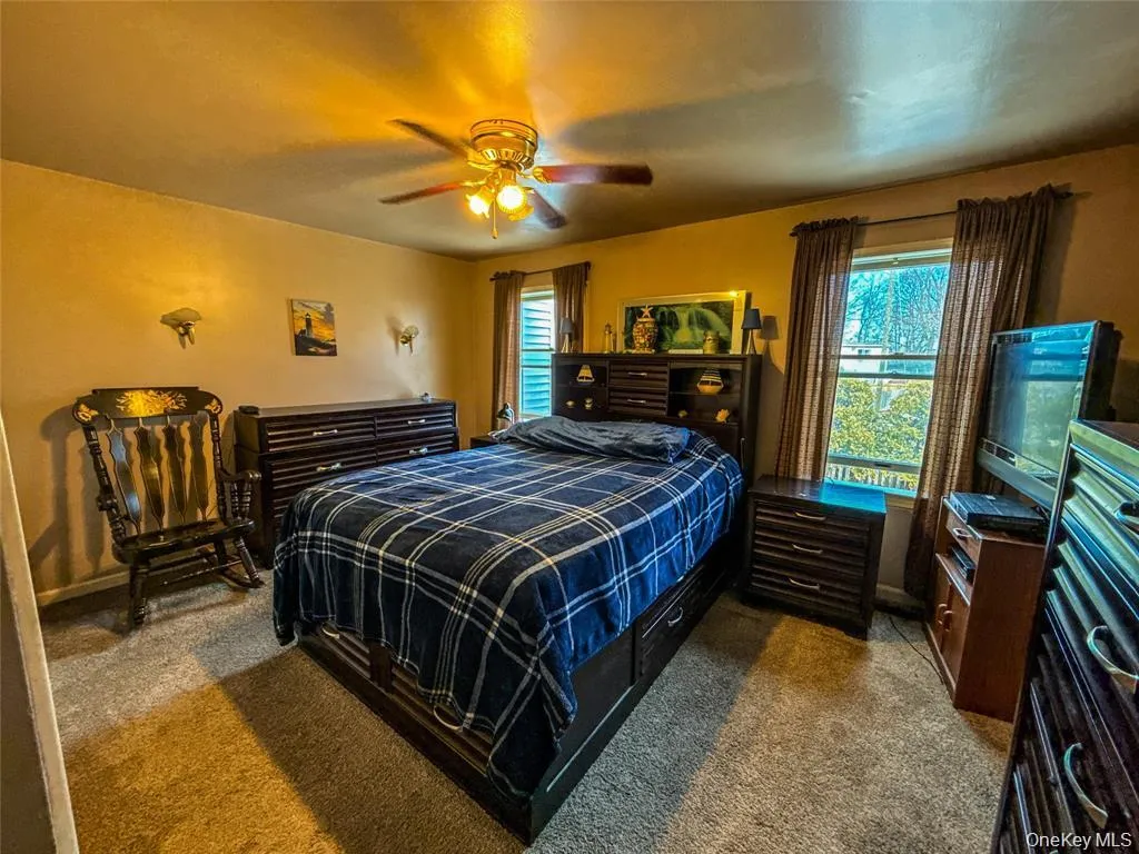 Bedroom with carpet floors and ceiling fan Bedroom with carpet floors and ceiling fan
