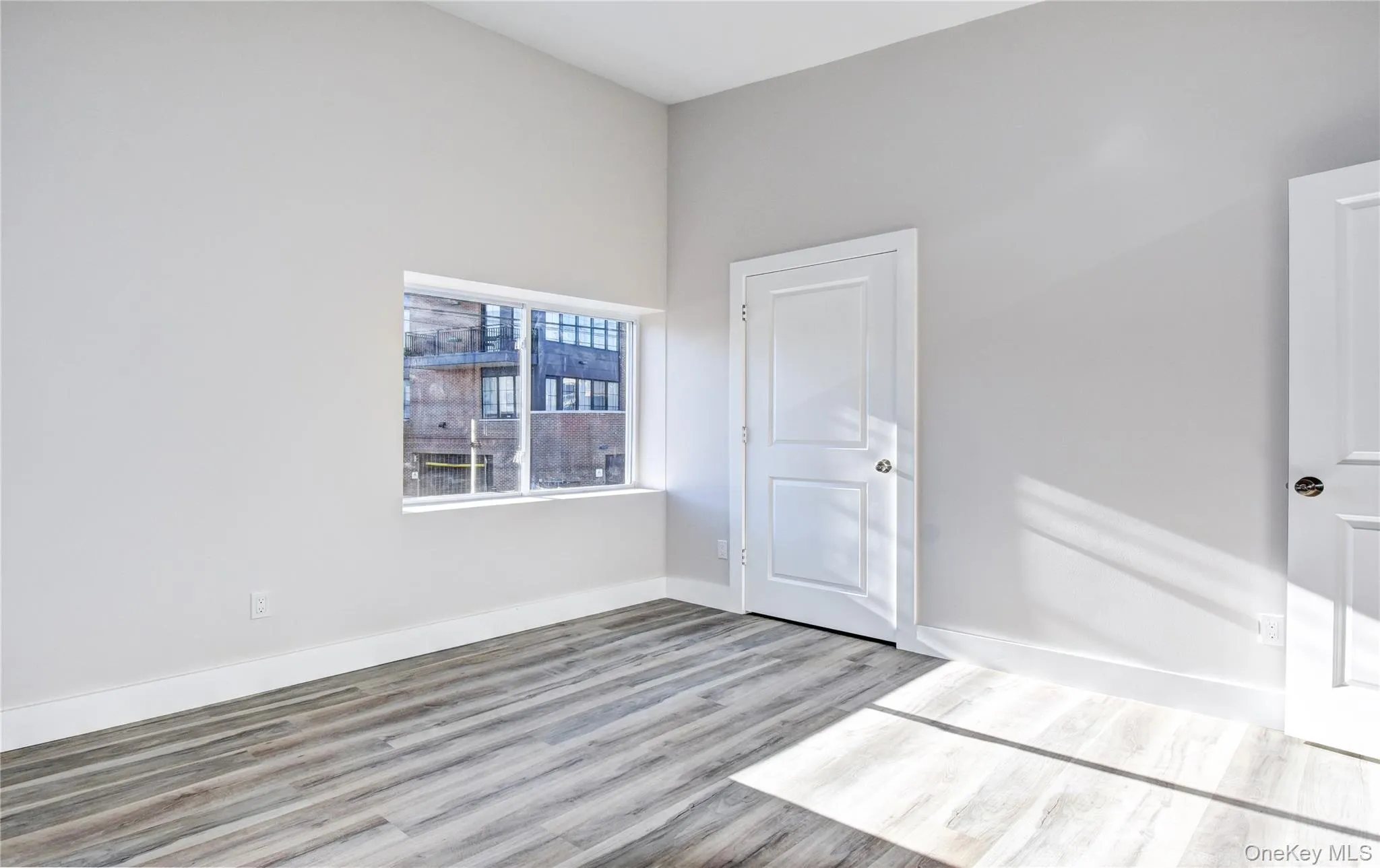 Spare room featuring wood finished floors and baseboards Spare room featuring wood finished floors and baseboards