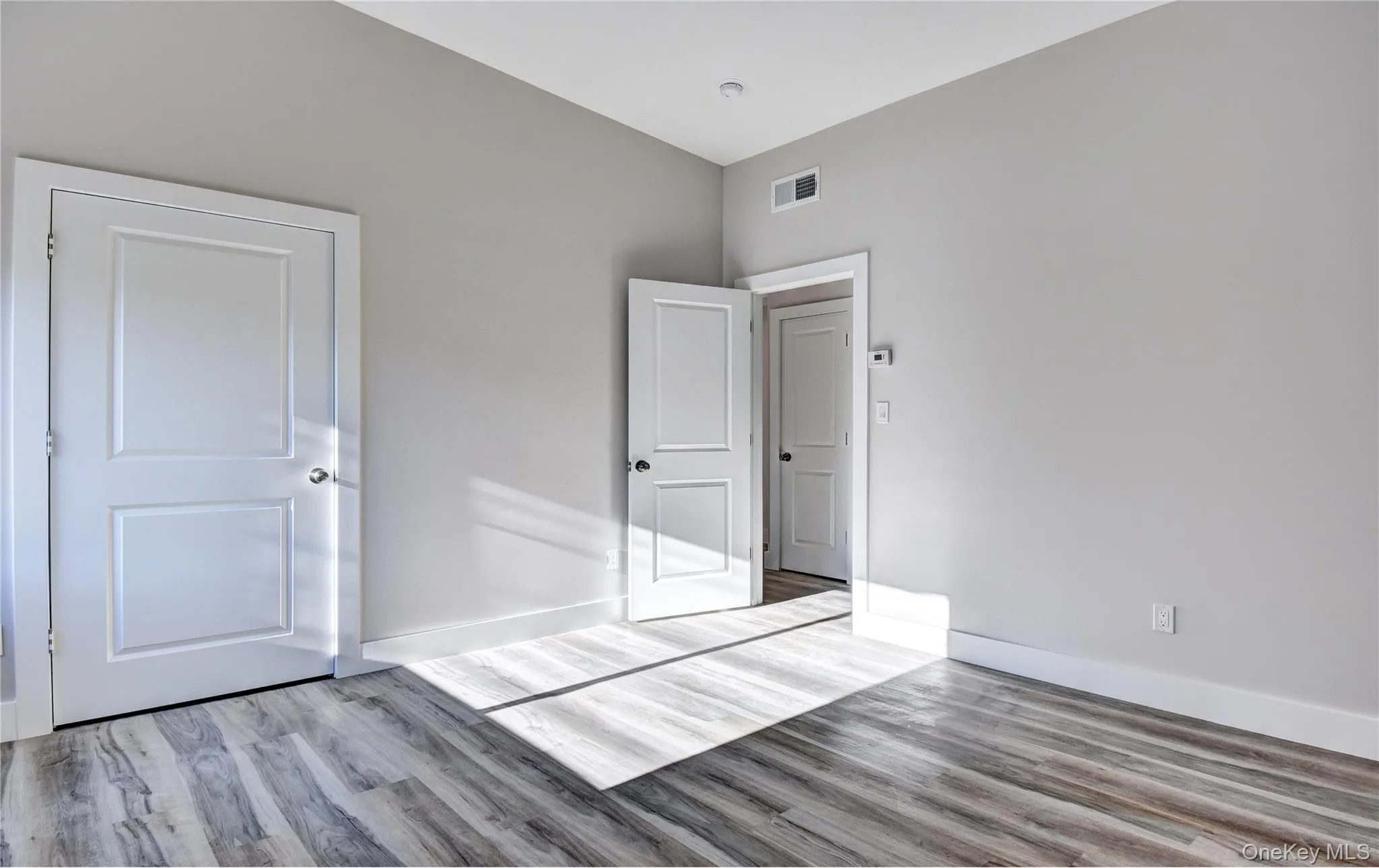 Unfurnished bedroom with wood finished floors Unfurnished bedroom with wood finished floors