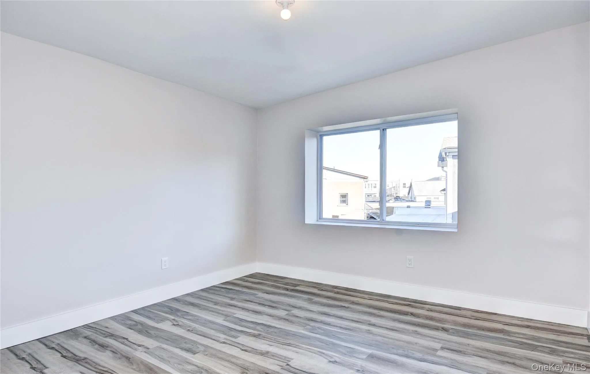 Empty room featuring baseboards and wood finished floors Empty room featuring baseboards and wood finished floors