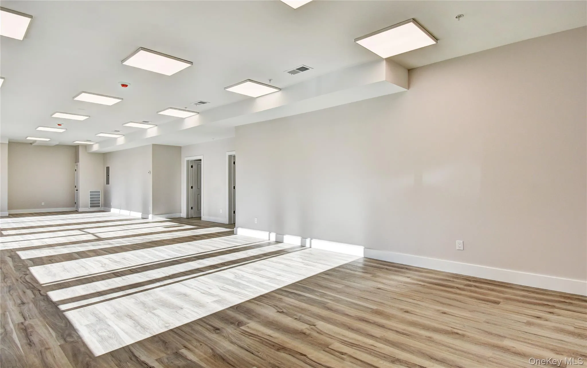 Unfurnished room featuring wood finished floors Unfurnished room featuring wood finished floors