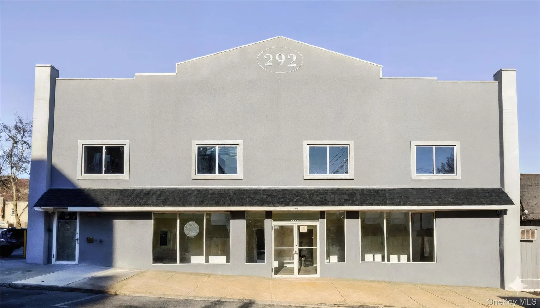 Rear view of house featuring stucco siding Rear view of house featuring stucco siding