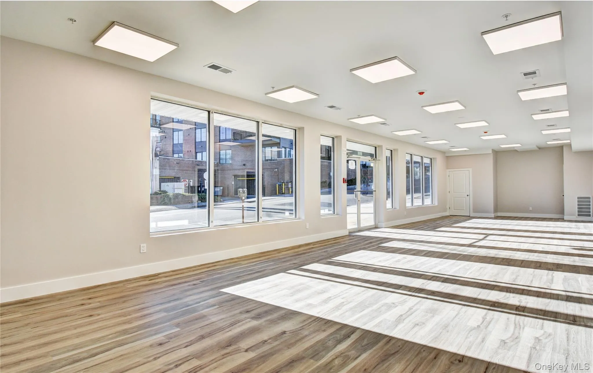 Unfurnished room with wood finished floors and baseboards Unfurnished room with wood finished floors and baseboards