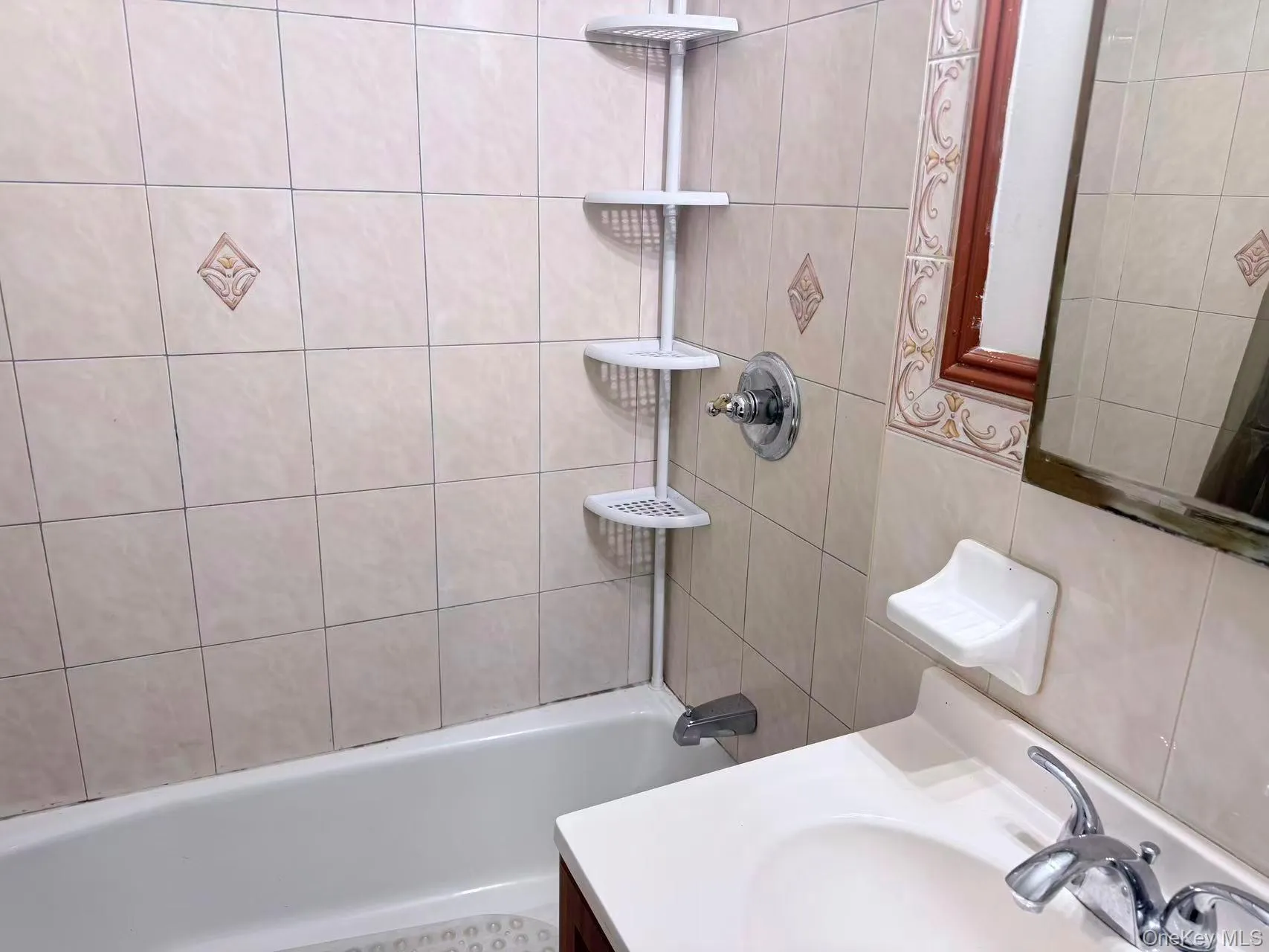 Bathroom featuring vanity and bathing tub / shower combination Bathroom featuring vanity and bathing tub / shower combination