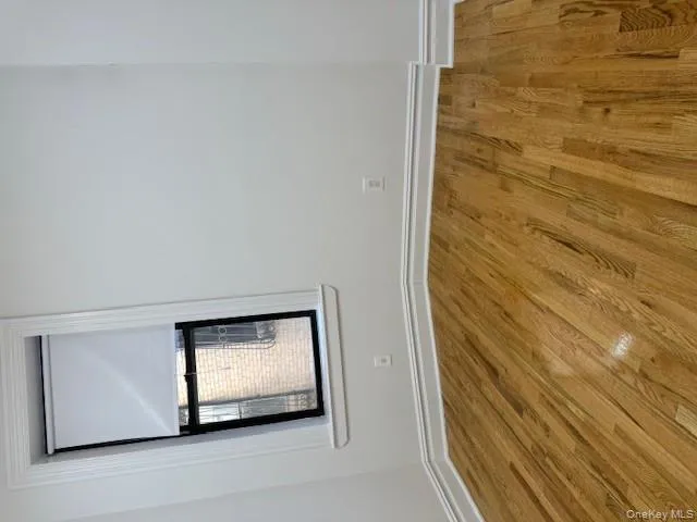 Unfurnished room featuring wood finished floors Unfurnished room featuring wood finished floors