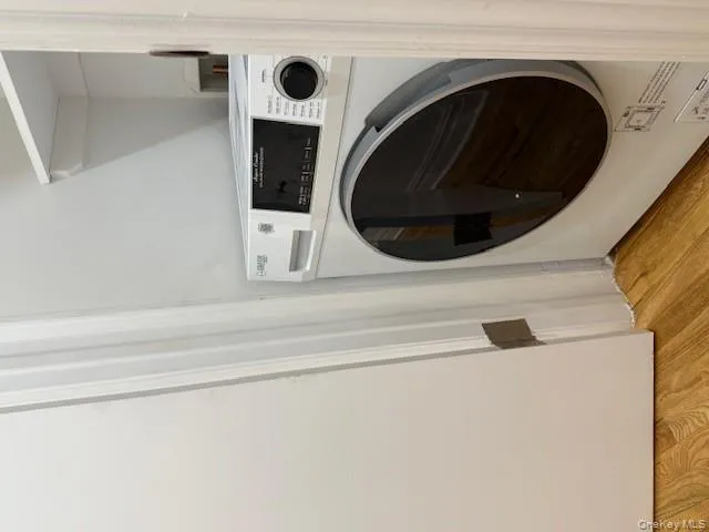 Laundry room with washer / dryer and light wood-style flooring Laundry room with washer / dryer and light wood-style flooring