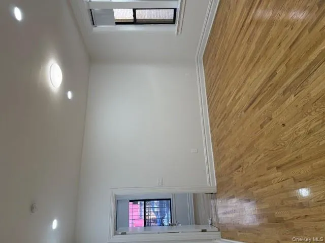 Unfurnished room with plenty of natural light, light wood finished floors, and recessed lighting Unfurnished room with plenty of natural light, light wood finished floors, and recessed lighting
