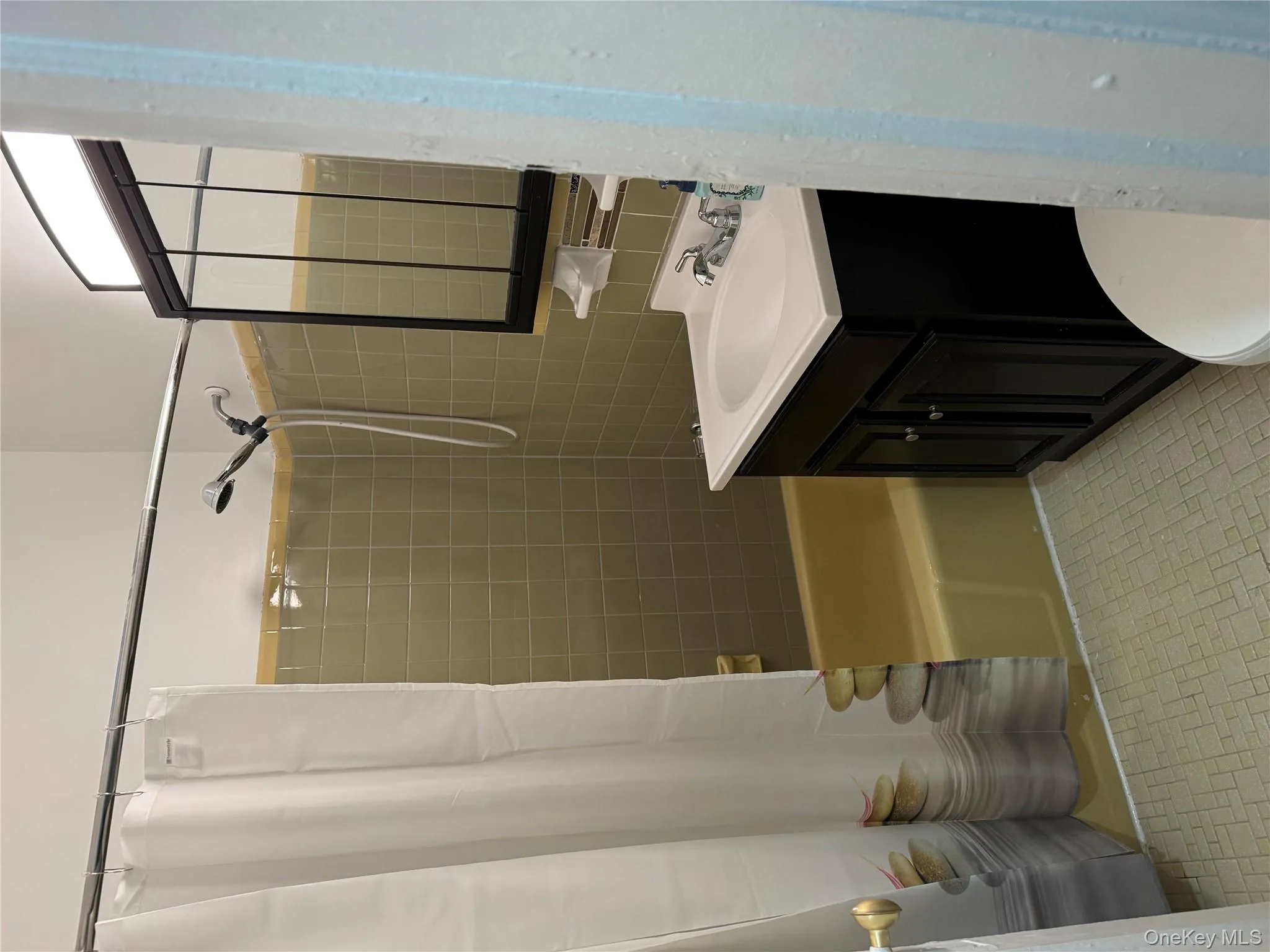 Full bathroom featuring vanity and shower / bath combination with curtain Full bathroom featuring vanity and shower / bath combination with curtain