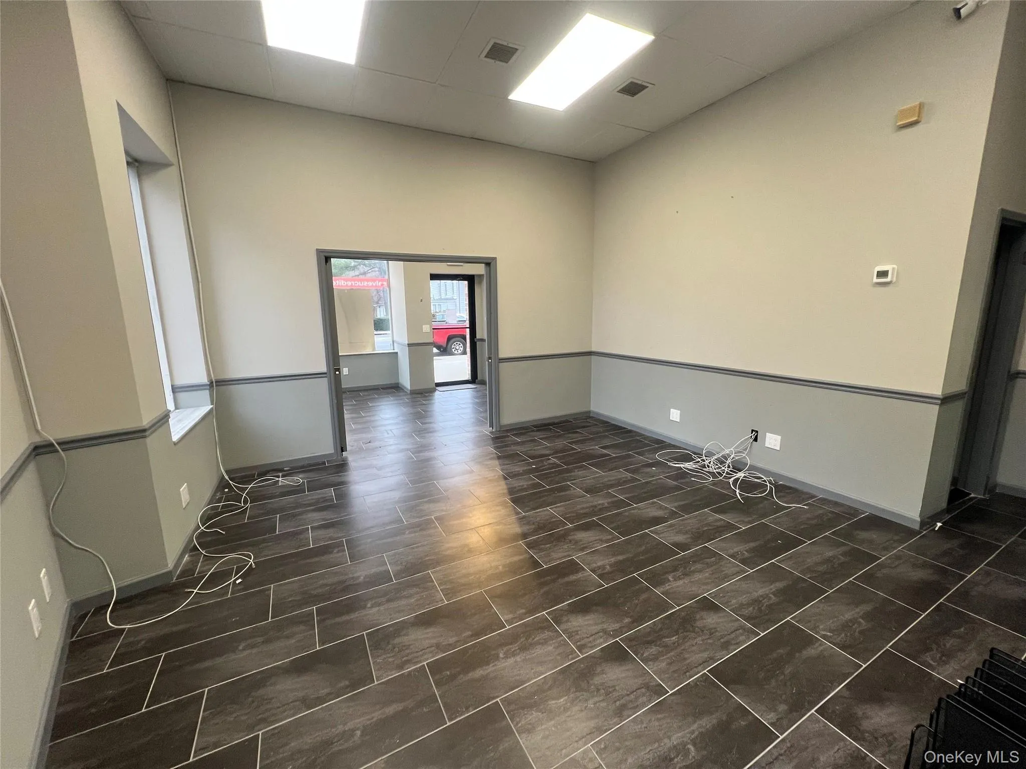 Empty room with a drop ceiling and a high ceiling Empty room with a drop ceiling and a high ceiling