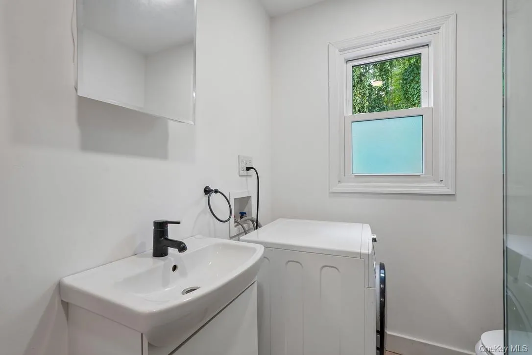 Main bathroom with washer/dryer combo unit Main bathroom with washer/dryer combo unit