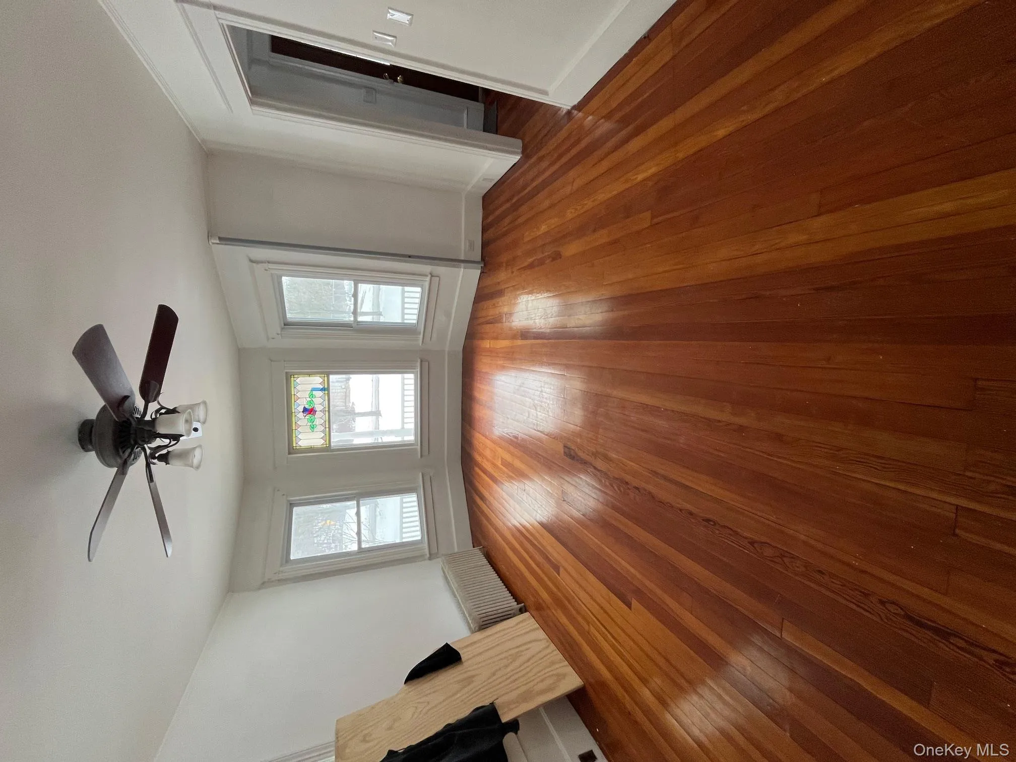 Family room with ceiling fan and hardwood floors Family room with ceiling fan and hardwood floors